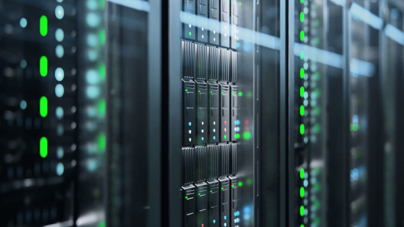 Rows of server racks with green lights.