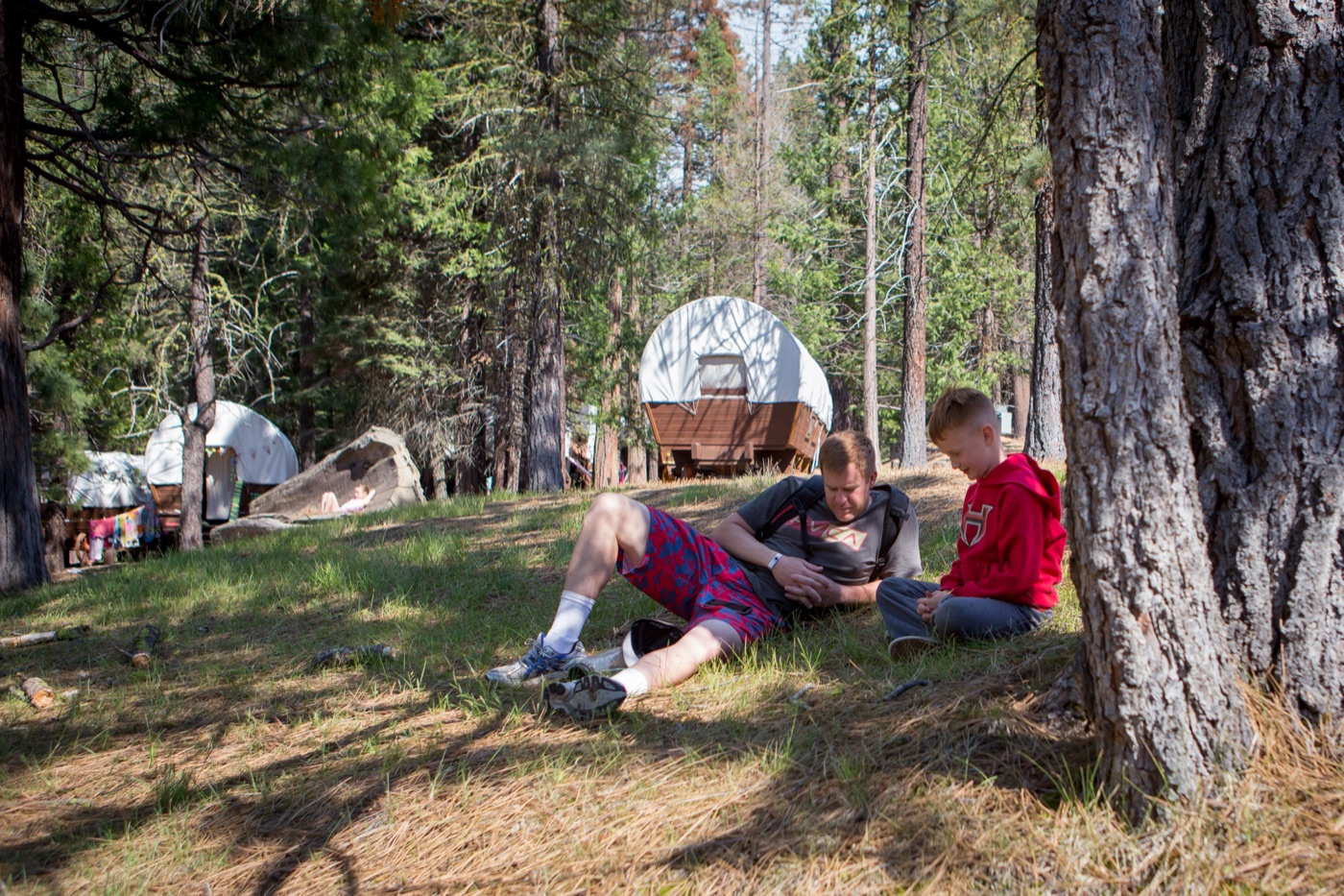 Campers resting by the covered wagons at Wagon Train.